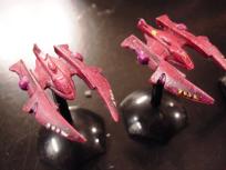 Two Talon fighters from Silent Death. I got these later than most of the ships, that's why the shade of red is wrong.